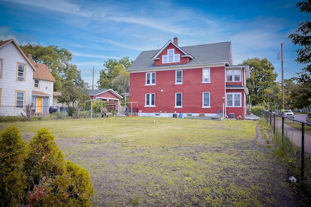 rear view of house with a lawn