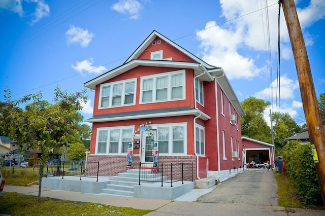 view of front of property featuring a garage and an outbuilding