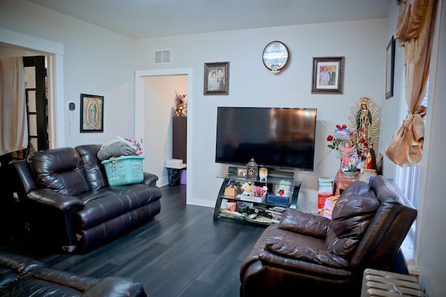 living room featuring dark hardwood / wood-style floors and radiator heating unit