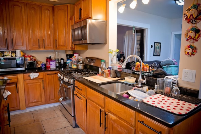 kitchen featuring sink, light tile patterned flooring, and stainless steel appliances