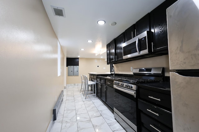 kitchen featuring a baseboard radiator, sink, and stainless steel appliances