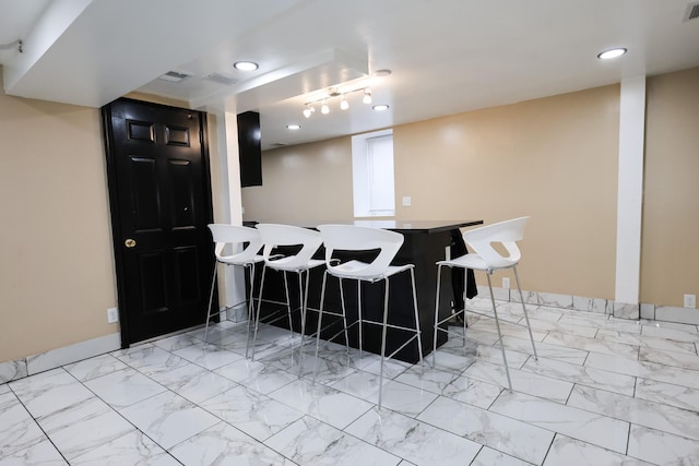 interior space featuring a kitchen breakfast bar and kitchen peninsula