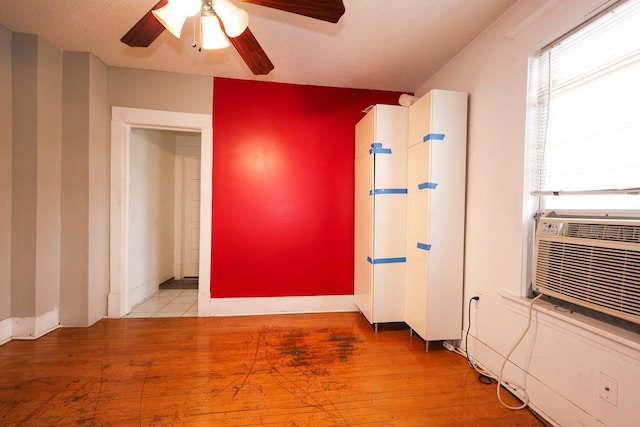 spare room featuring light wood-type flooring and ceiling fan