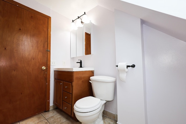 bathroom featuring tile patterned floors, toilet, and vanity