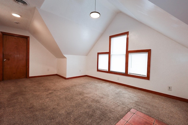 bonus room with lofted ceiling and carpet flooring