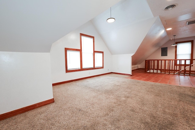 additional living space with light colored carpet and lofted ceiling