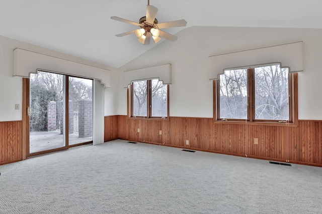 unfurnished room with ceiling fan, vaulted ceiling, and light carpet