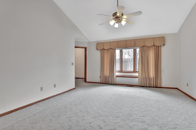 carpeted empty room featuring ceiling fan and lofted ceiling