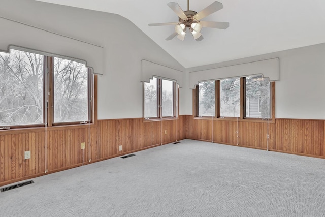 empty room featuring light carpet, ceiling fan, and lofted ceiling