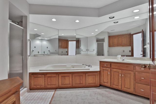 bathroom featuring vanity and shower with separate bathtub