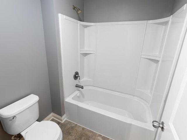 bathroom featuring bathtub / shower combination and toilet