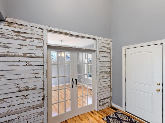 doorway with light hardwood / wood-style floors and french doors