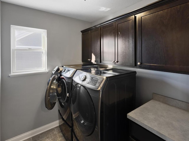 washroom with independent washer and dryer, tile patterned floors, and cabinets