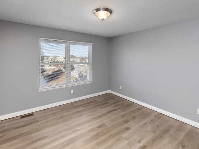 spare room with light hardwood / wood-style floors