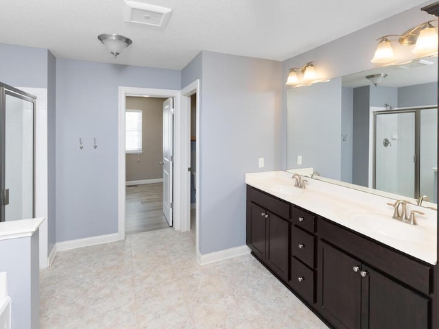 bathroom with vanity and a shower with shower door