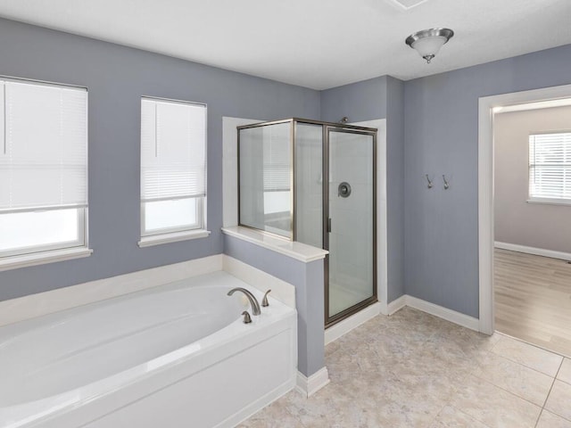 bathroom featuring plenty of natural light, tile patterned floors, and separate shower and tub