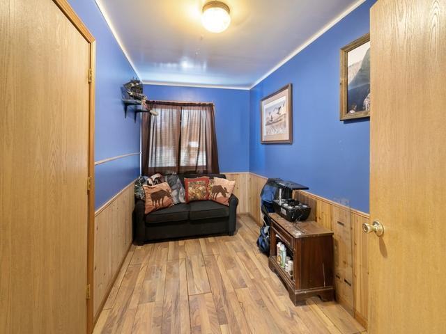 living room featuring wood walls and light wood-type flooring