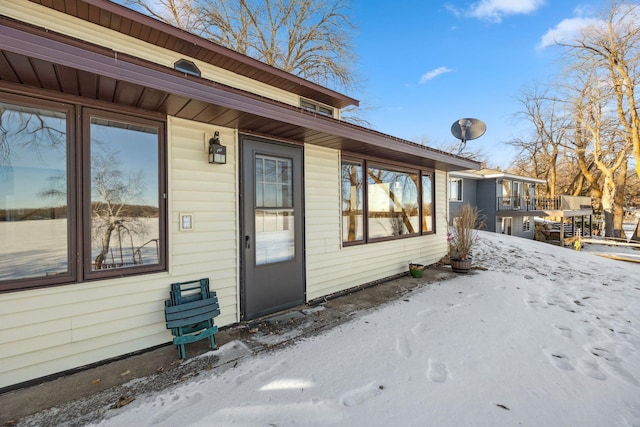 view of snow covered property entrance