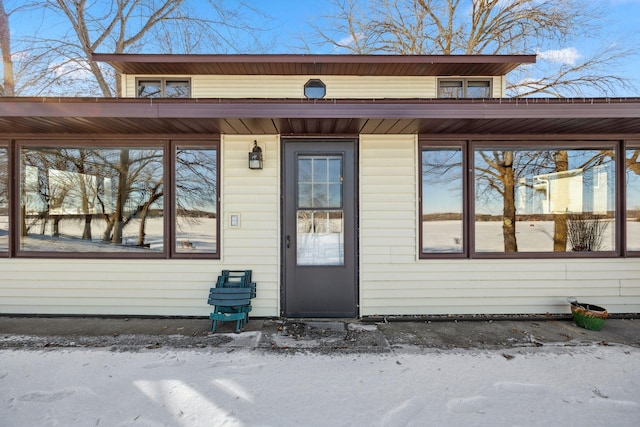 view of snow covered property entrance