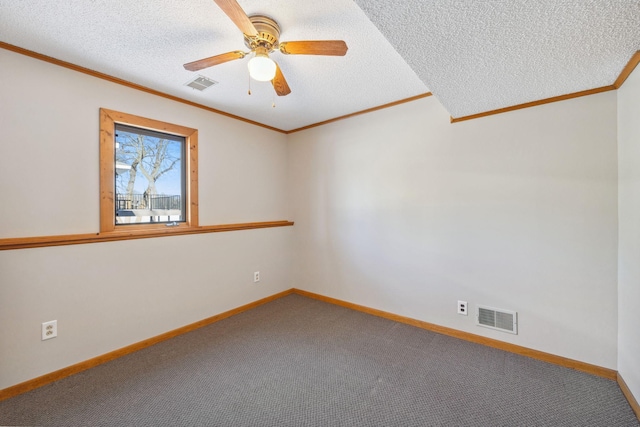 empty room featuring crown molding, carpet floors, a textured ceiling, and ceiling fan