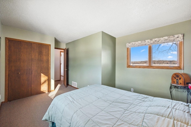 carpeted bedroom with a closet