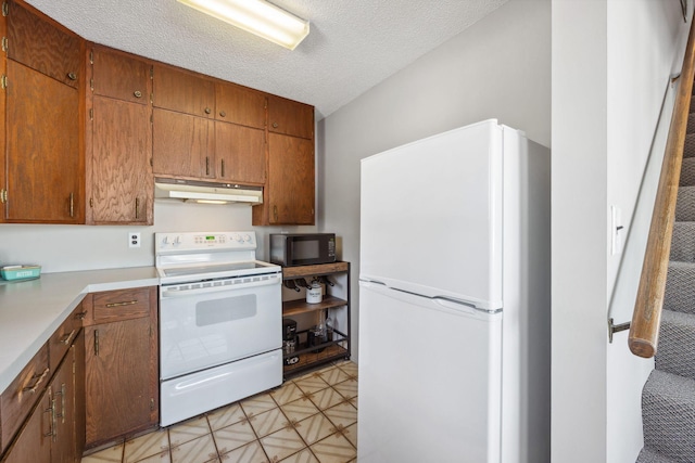 7364 Isaak Ave NW, Annandale, MN 55302 - kitchen featuring white appliances, under cabinet range hood, light countertops, a heating unit, and a textured ceiling