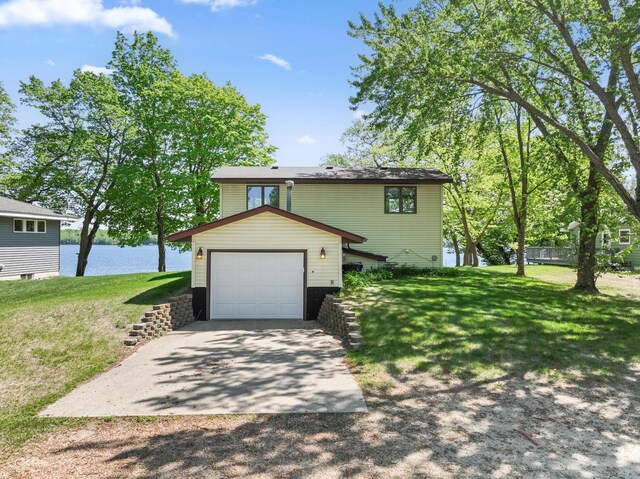 7364 Isaak Ave NW, Annandale, MN 55302 - view of front of home featuring a water view, concrete driveway, and a front lawn