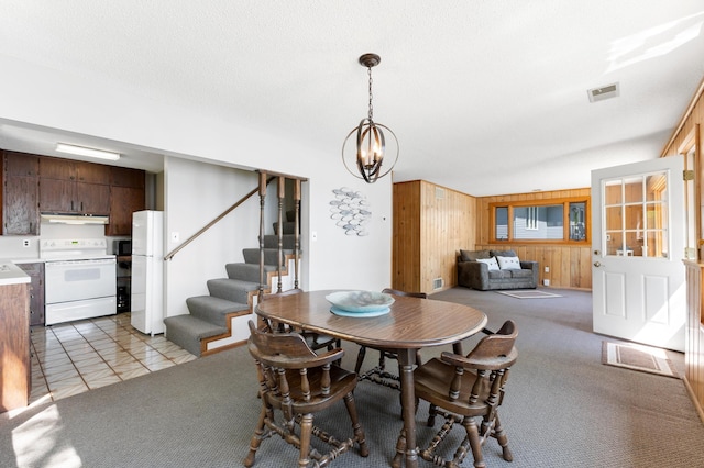 7364 Isaak Ave NW, Annandale, MN 55302 - dining room featuring wooden walls, stairs, a chandelier, and light colored carpet