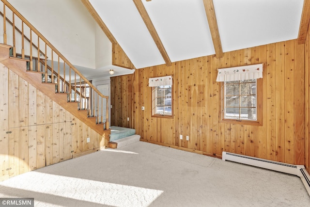 unfurnished living room with a baseboard heating unit, a wealth of natural light, carpet, and lofted ceiling with beams