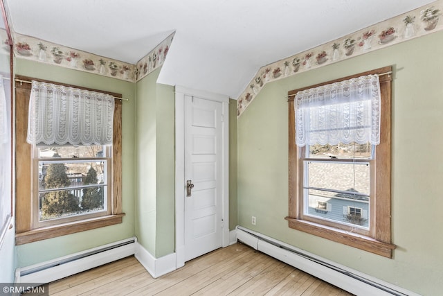 interior space with light hardwood / wood-style floors and a baseboard heating unit