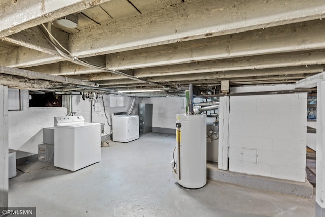 basement with washer and clothes dryer and water heater