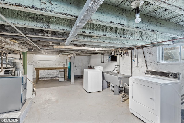 basement featuring sink and independent washer and dryer