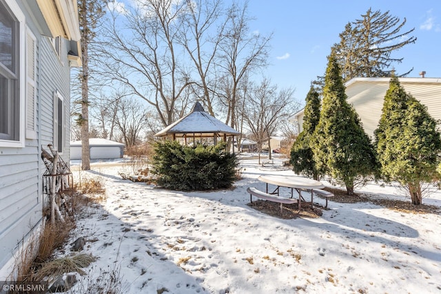 yard covered in snow with a gazebo