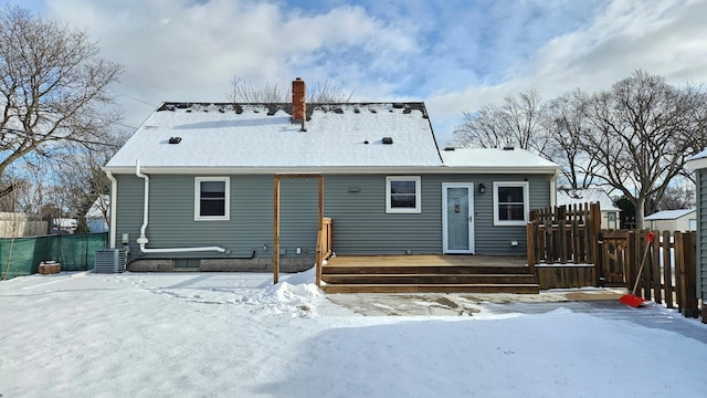 snow covered house featuring a wooden deck and central AC