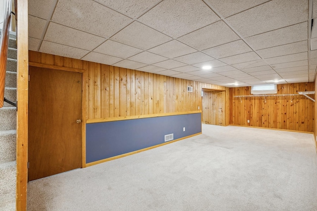 basement with carpet floors and a wall unit AC