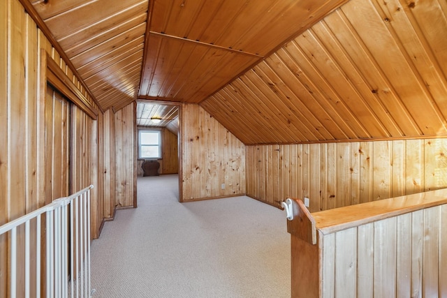 bonus room with vaulted ceiling, carpet, wooden ceiling, and wooden walls