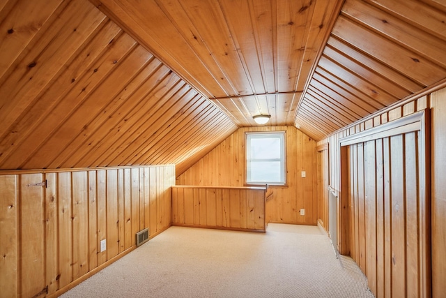 bonus room with lofted ceiling, wood ceiling, wooden walls, and light carpet