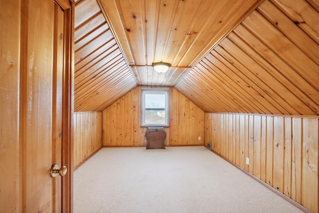 bonus room with light colored carpet, lofted ceiling, wood walls, and wooden ceiling