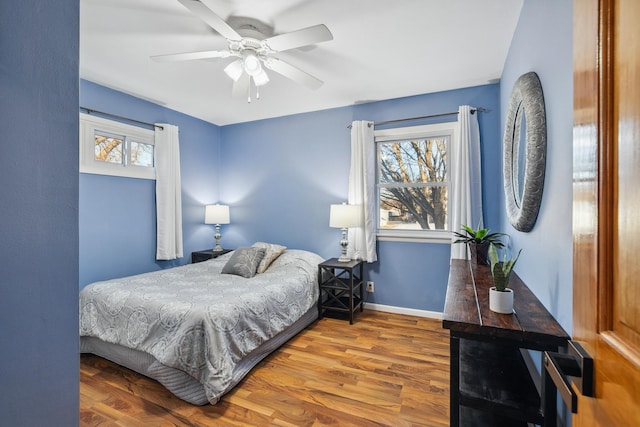 bedroom with ceiling fan and hardwood / wood-style floors