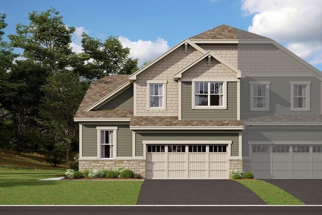 craftsman-style house featuring a garage and a front lawn