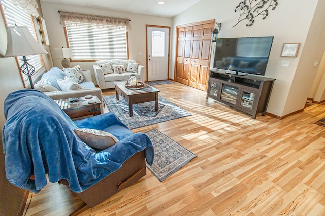 living room featuring lofted ceiling and hardwood / wood-style floors