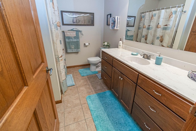 bathroom featuring toilet, vanity, and tile patterned flooring