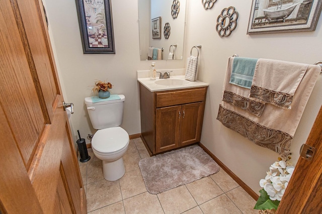 bathroom with toilet, tile patterned flooring, and vanity