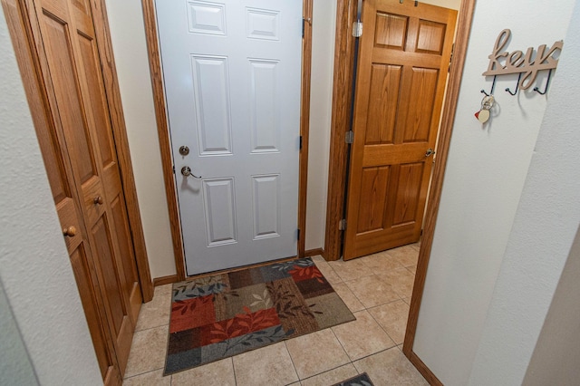 hall featuring light tile patterned floors