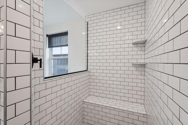 bathroom featuring tiled shower