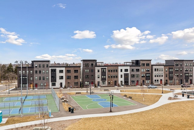 view of community featuring tennis court and basketball hoop