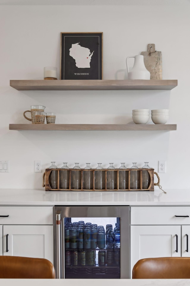 bar with white cabinetry and wine cooler