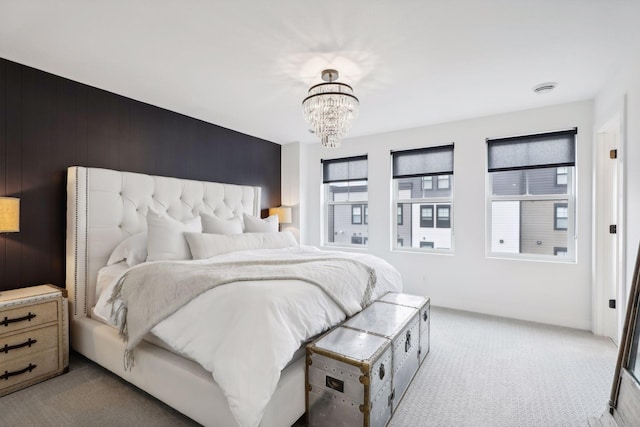 bedroom featuring an inviting chandelier and carpet floors