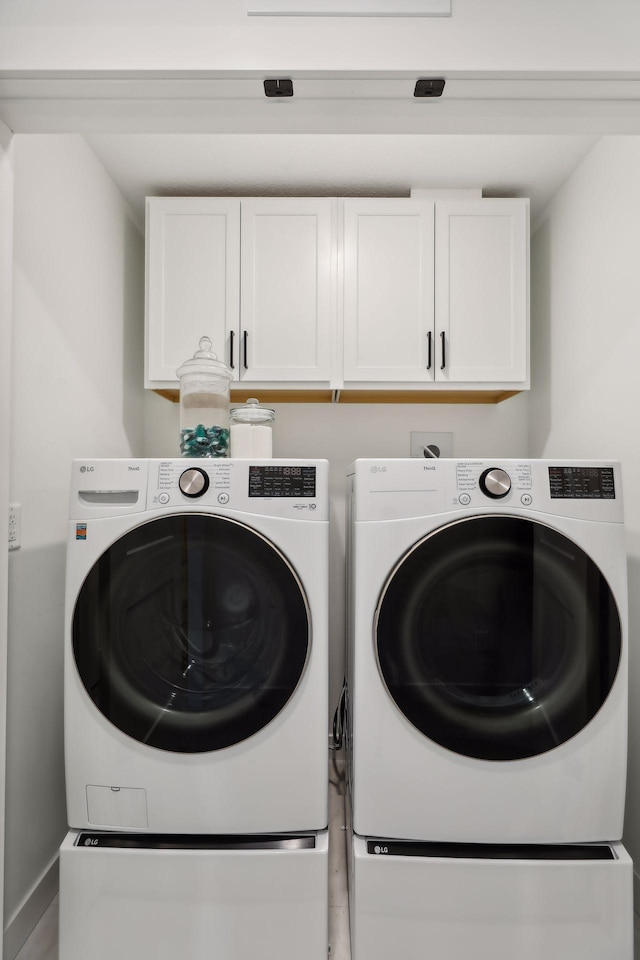 laundry room featuring washer and dryer and cabinet space