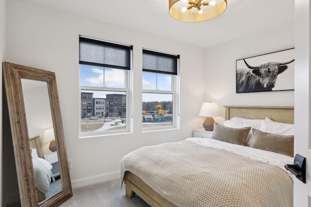 carpeted bedroom featuring baseboards